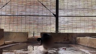 JAPANESE GIRL BATHING IN A MIXED OUTDOOR BATH AT A HOT SPRING INN