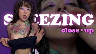 LOUD, WET SNEEZES. CLOSE-UP.