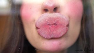 PILLOW-SOFT GLOSSED LIPS IN A MELTING SENSUAL KISS