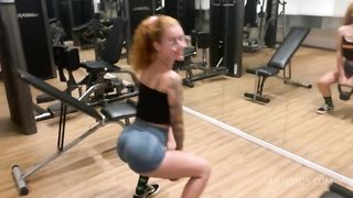 Naughty redhead was surprised at the gym by her friend and fell head over heels before being fucked