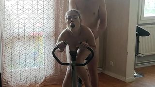 COQUETTE IN LEGGINGS GETS FUCKED DOGGY STYLE ON THE EXERCISE BIKE