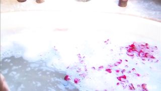 Steamy session with blond and dude in sudsy and rose petal filled tub.
