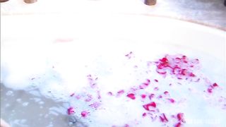 Steamy session with blond and dude in sudsy and rose petal filled tub.
