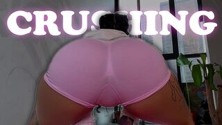 THE TATTOOED GIRL STRUGGLES WITH THE SHRUNKEN MAN AND CRUSHES HIM AGAINST HER YOGA BALL.